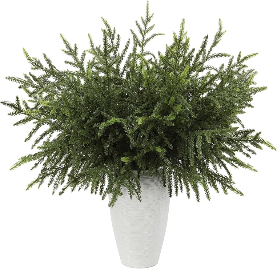 Faux Norfolk pine stems in a white vase