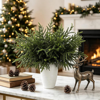 Norfolk pine stems in a vase by a Christmas tree and fireplace