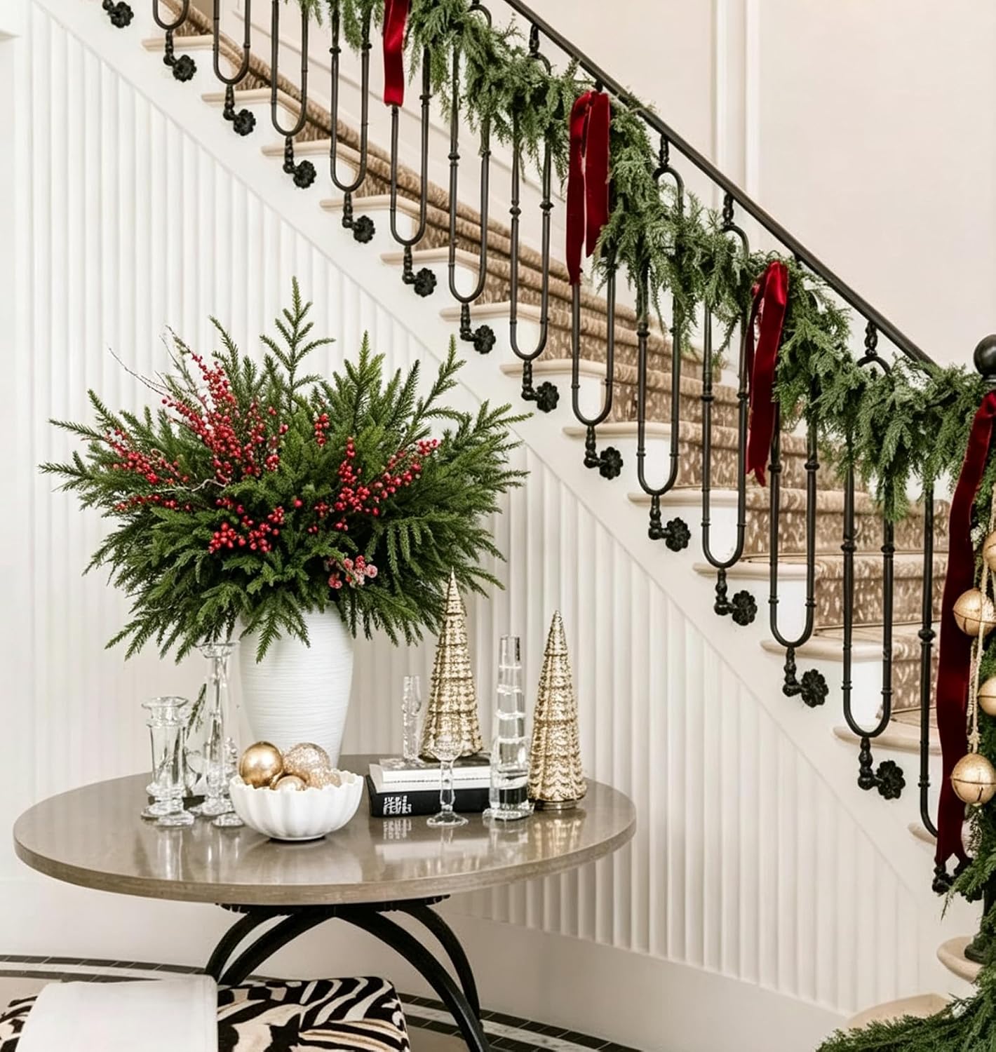 Norfolk pine stems with red berries in a vase by a staircase